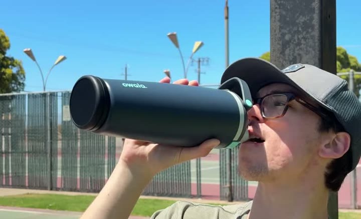 Drinking from a bottle held on its side, with the Sponge Clip visible on its base